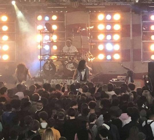 Packed crowd in front of a lit stage